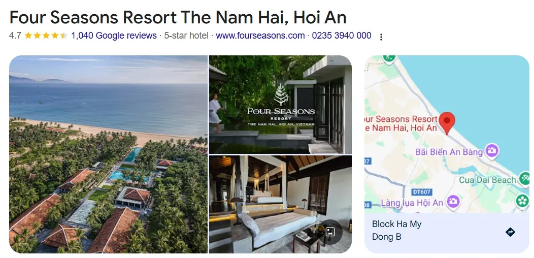 一張寧靜度假村全景圖,展示會安度假村內的熱帶花園、無邊泳池與融合越式建築的現代設計,賓客悠閒散步其中